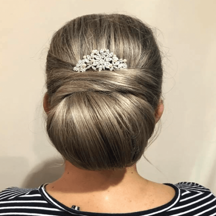 Get Smart Hair back of woman's head with formal hair style with flower detail clip
