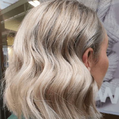 Get Smart Hair back of woman's head with wavy blonde medium length hair